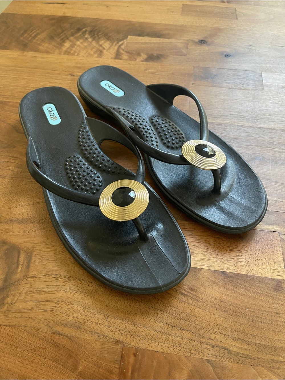 OKA b. Black Thong Sandals with Gold Medallion
